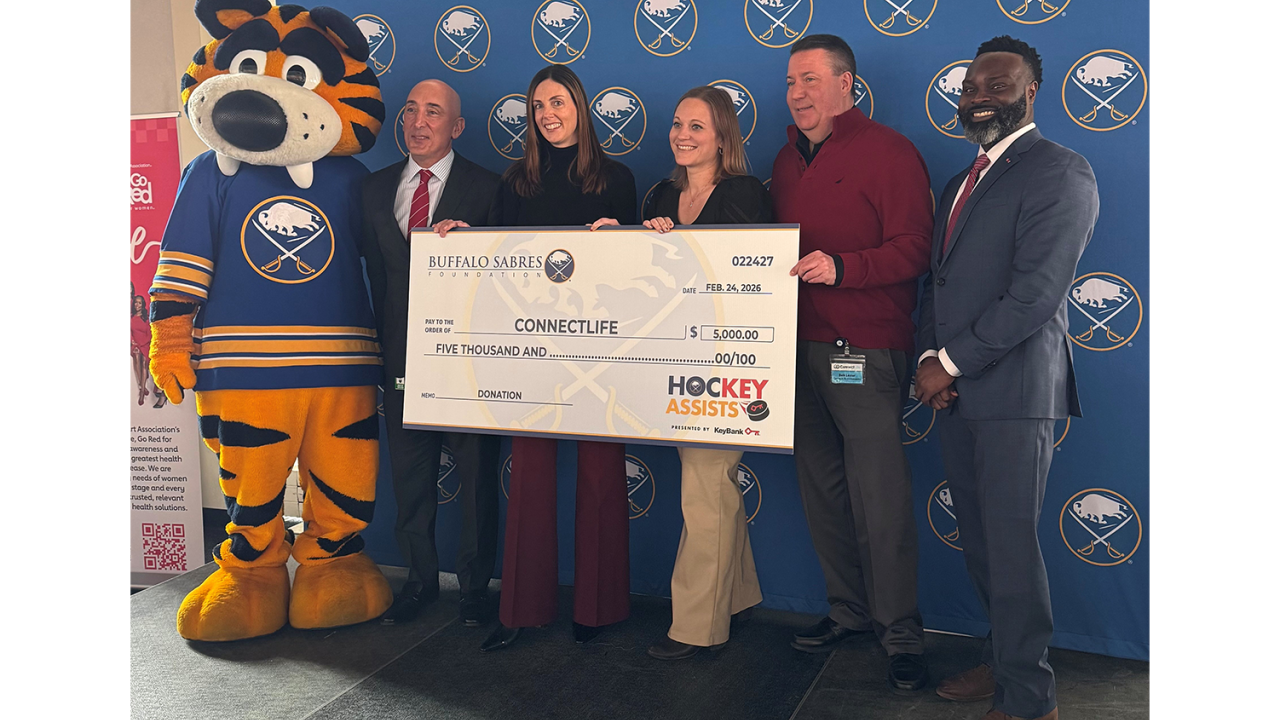 People standing with an oversized check