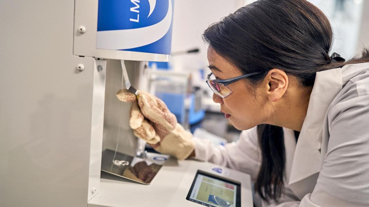 Lab worker performs a test using a machine