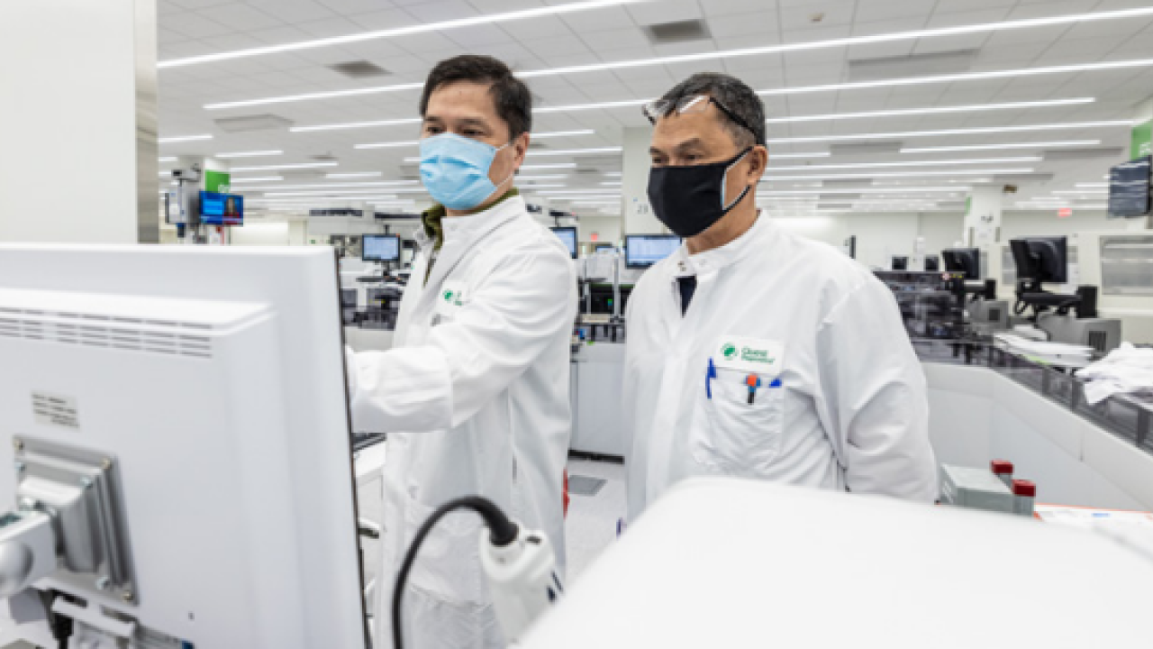Two people in lab coats in a lab