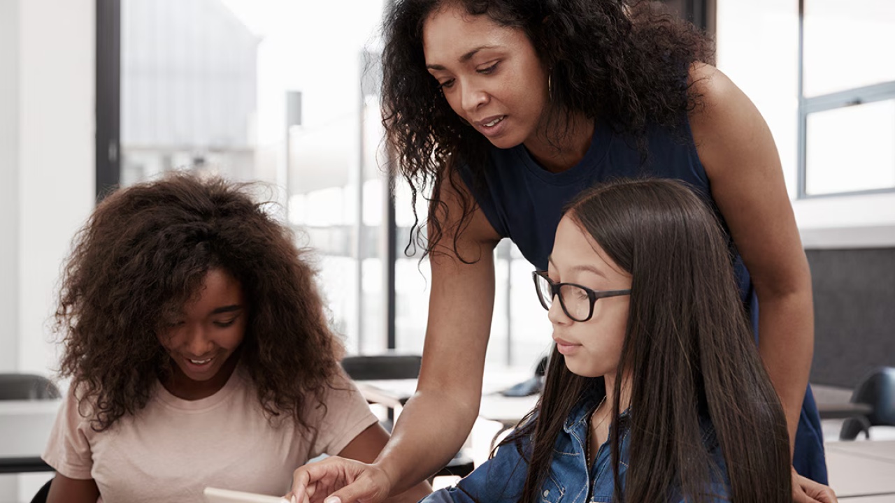adult and two children on a computer