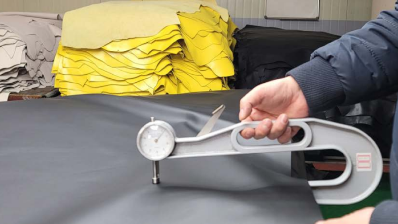 Trained quality inspectors measuring leather thickness, 