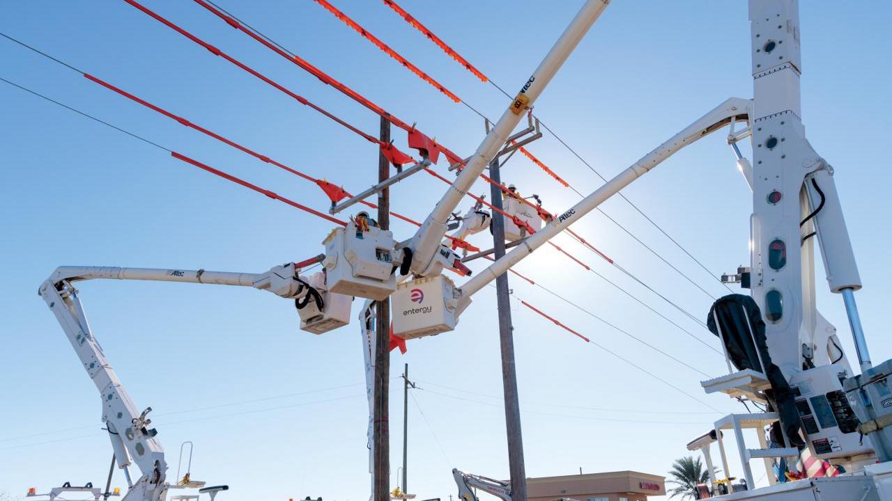 A person in a raised bucket working on a power line.