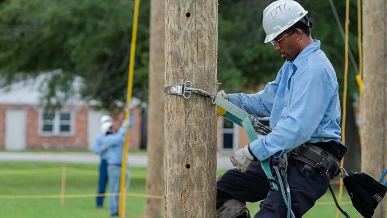 Lineworker on telephone pole