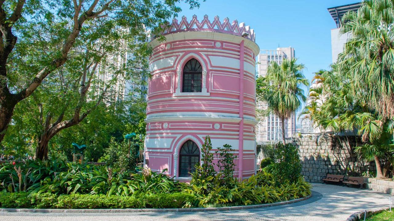 A round structure in a park setting, colorfully painted.