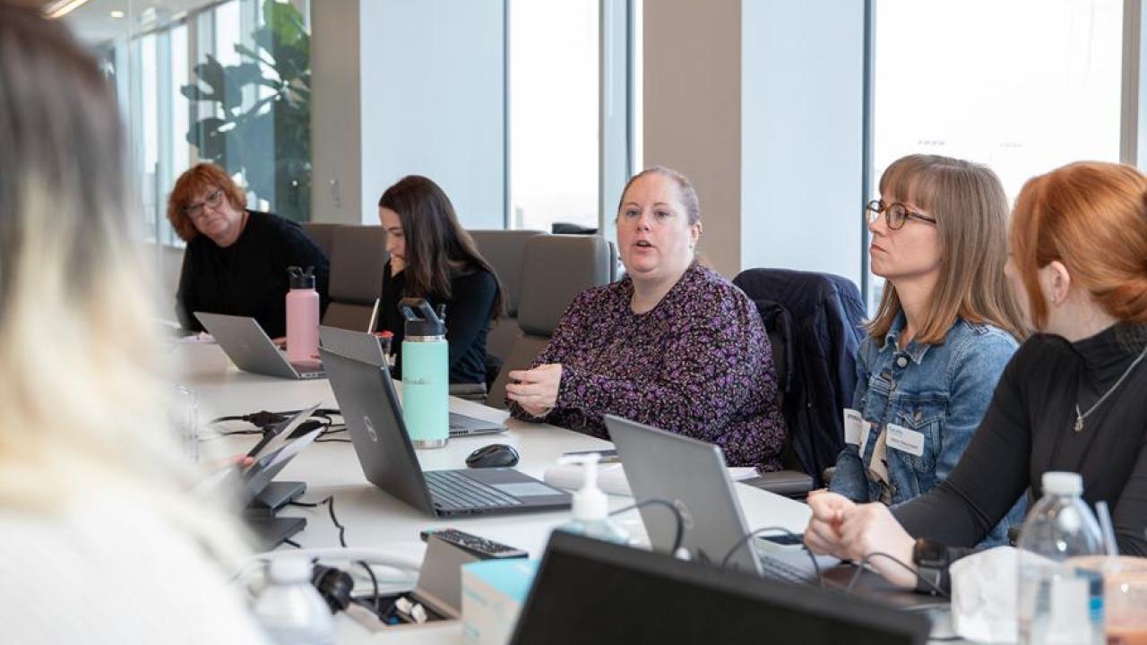 6 people pictured at a meeting