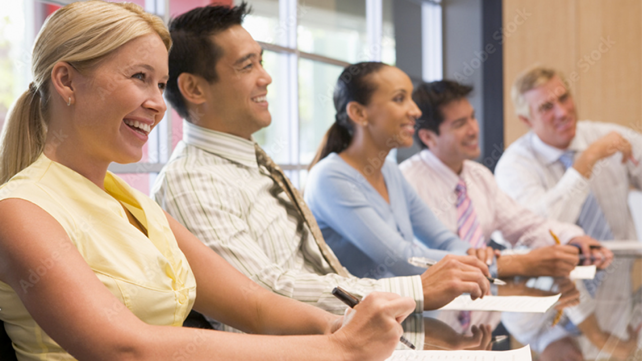 Group of people in a meeting looking cheerful