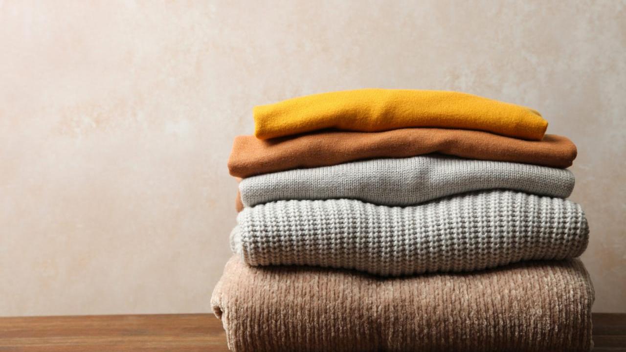 folded sweaters on a table