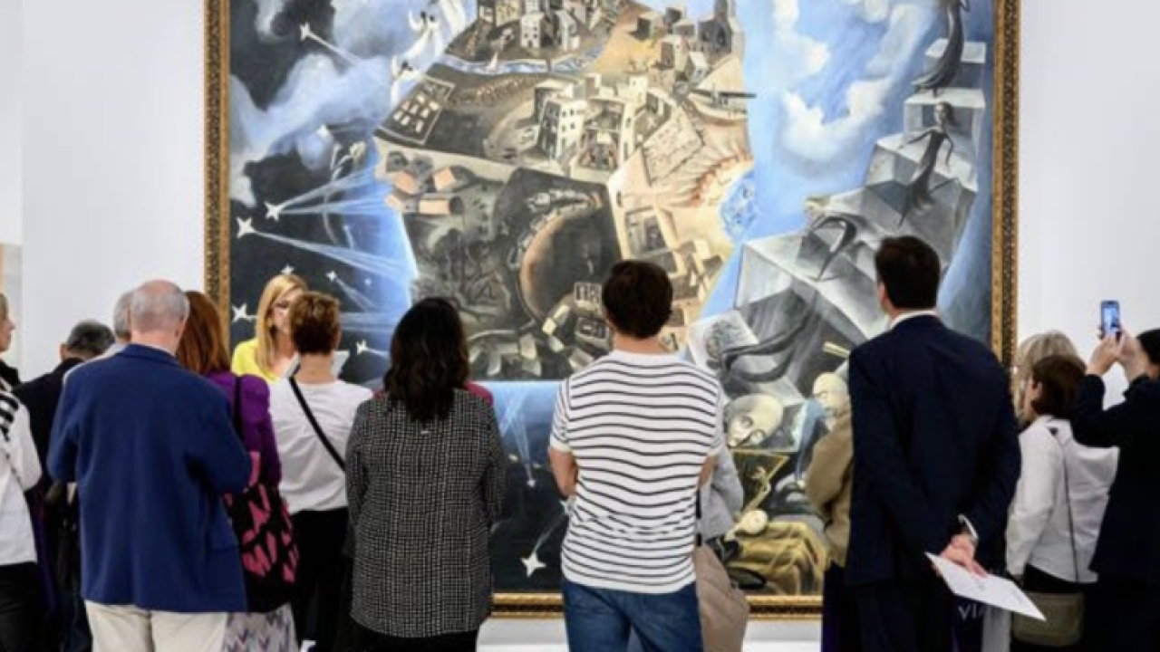 Group viewing large painting