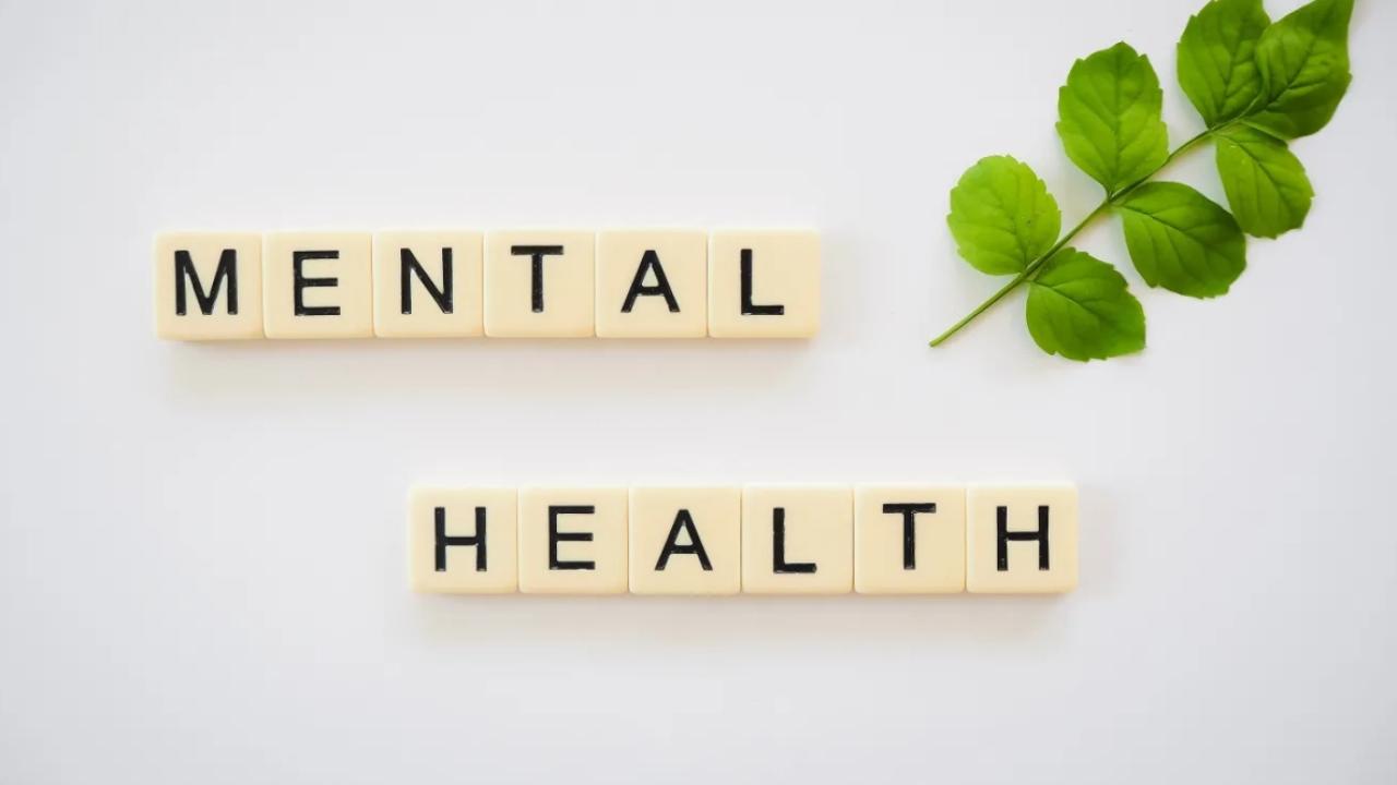 mental health spelled out in tiles. A green leaf in the corner
