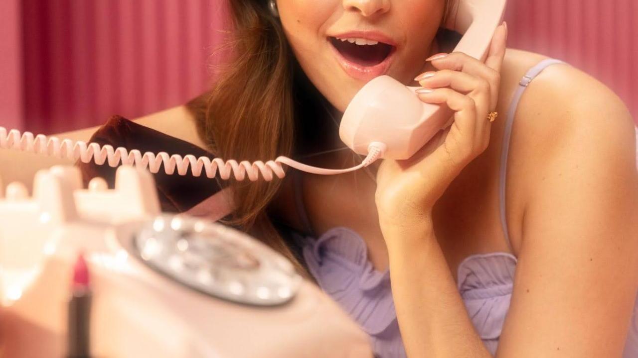 person talking on a landline phone