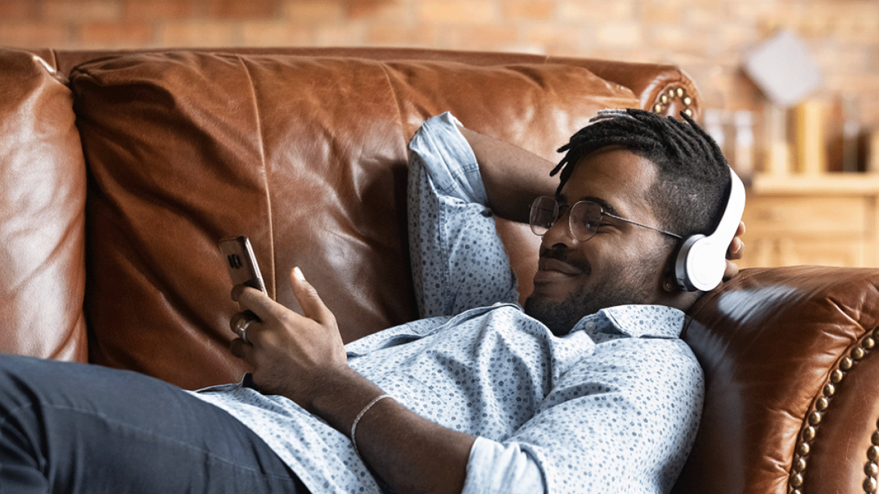 Mobile phone user unwinding on the sofa