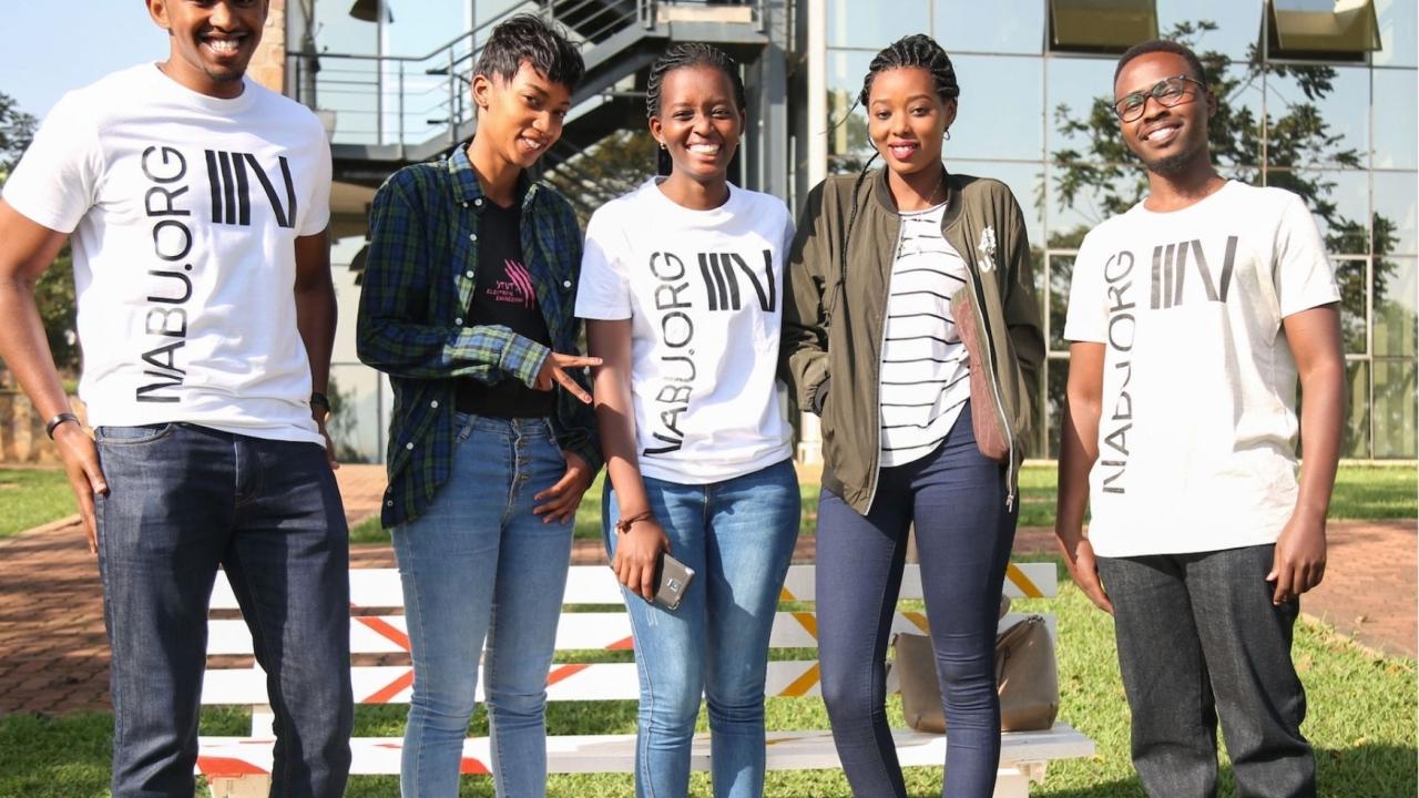 5 people standing together smiling