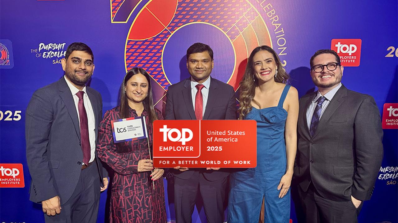 Five people holding an award