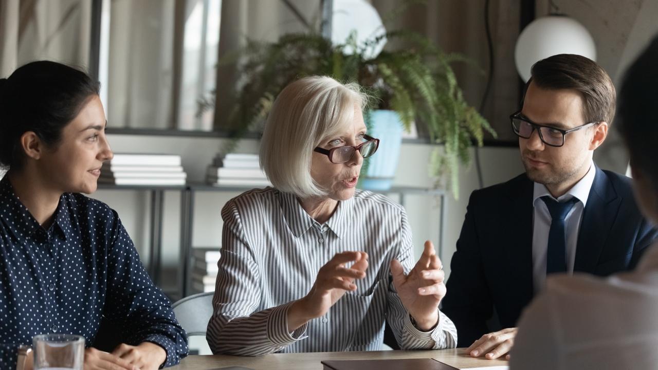 business people speaking around a table