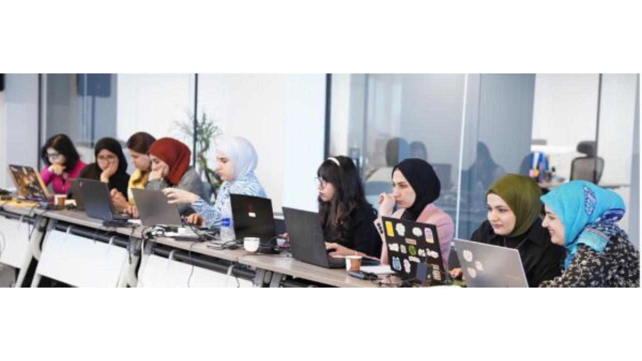 Group of young women on laptops
