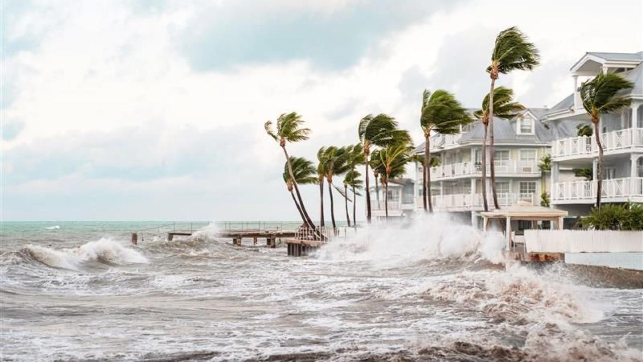 Stormy seas next to apartment buildings