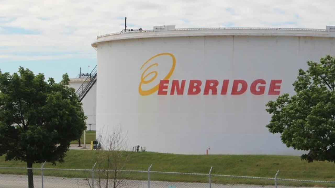 Large outdoor holding tank with Enbridge logo on the side
