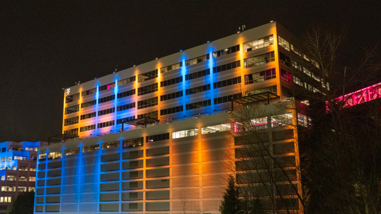 T-Mobile Headquarters in Bellevue, WA lit up in yellow and blue lights