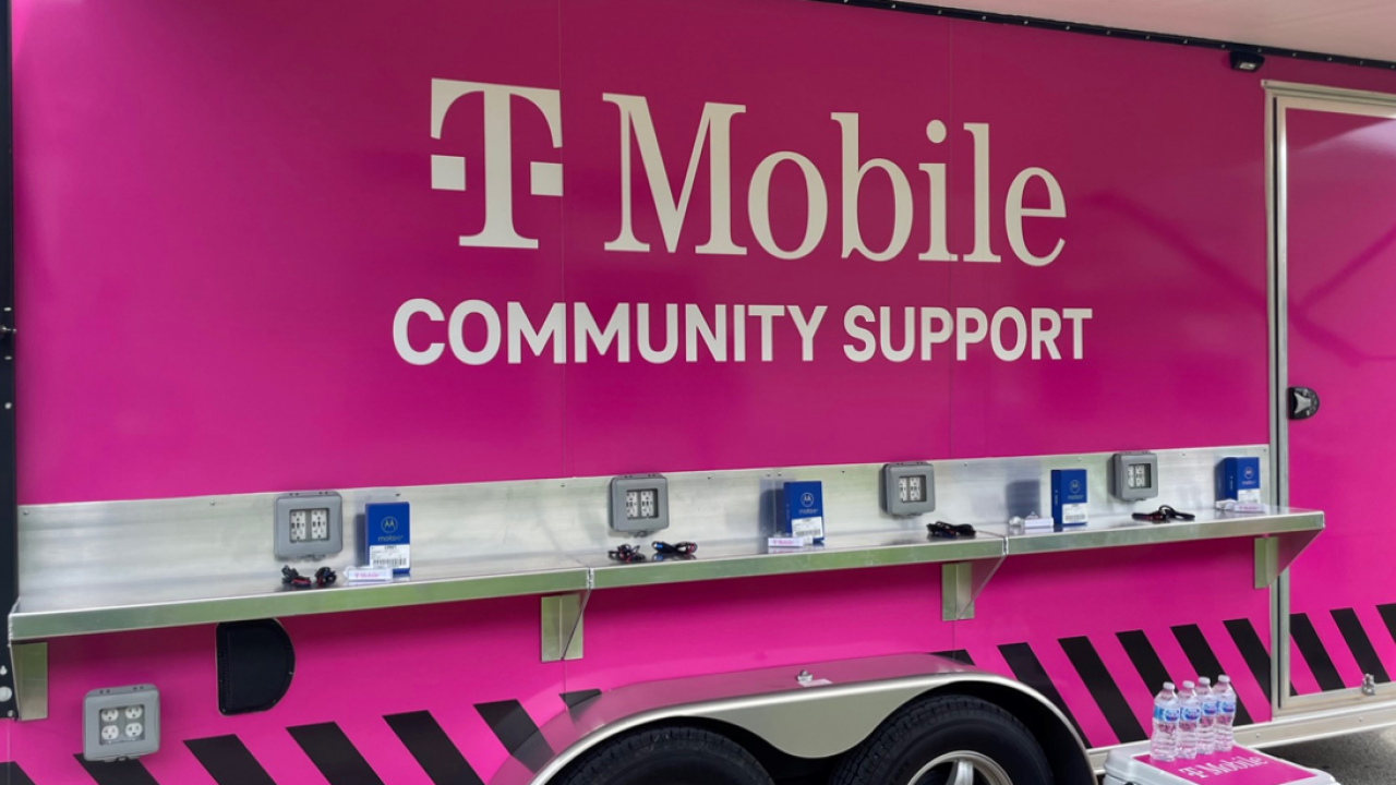 TMobile logo on the side of a pink vehicle "community support" equipped with charging ports