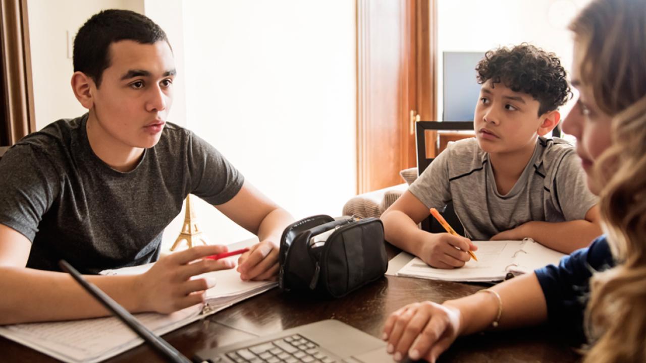 Students sitting around a laptop