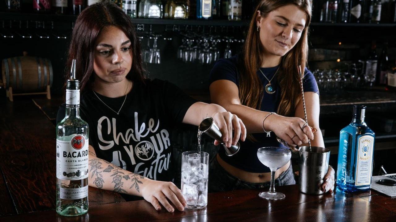 Two people mixing drinks