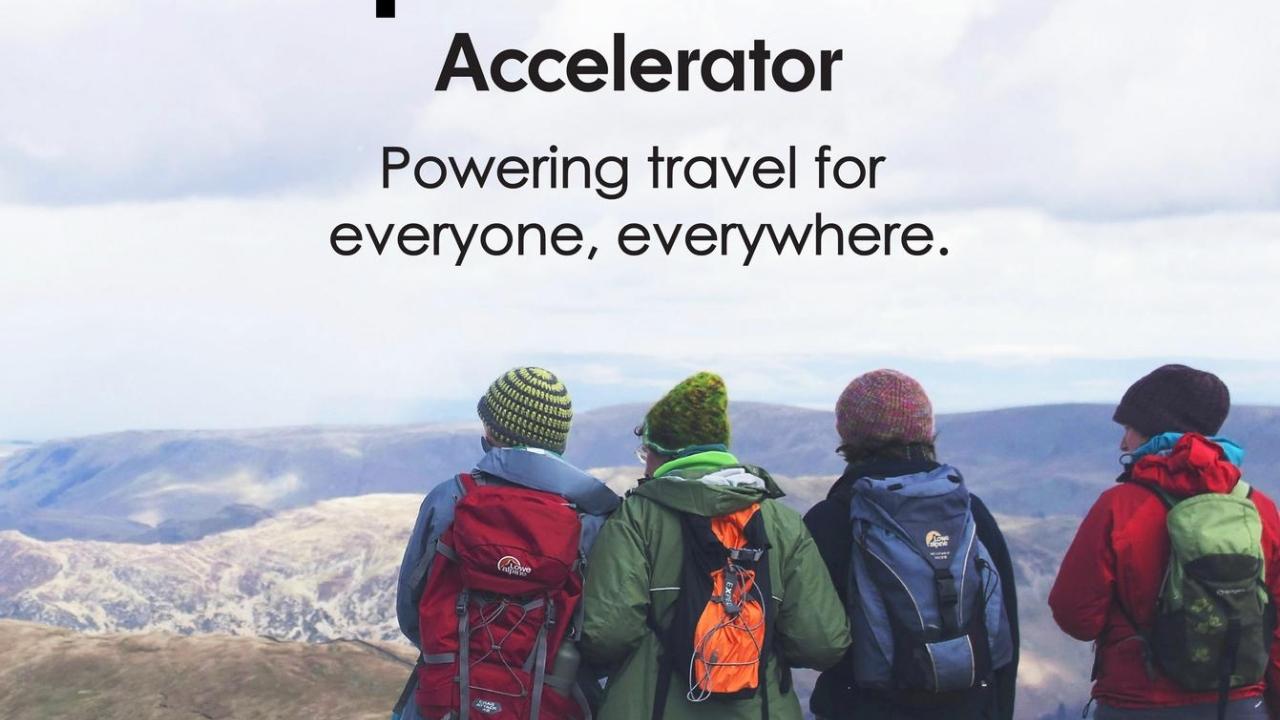 Four people in hiking gear looking at a panoramic view. "Open World Accelerator Powering travel for everyone, everywhere."
