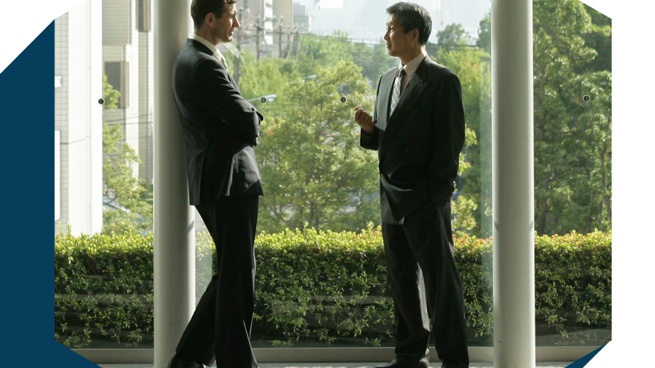 two people in suits talking together