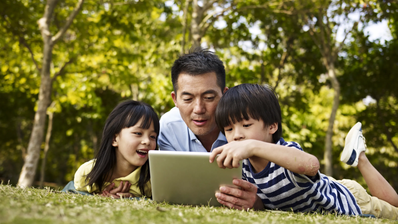 parent and children on a laptop