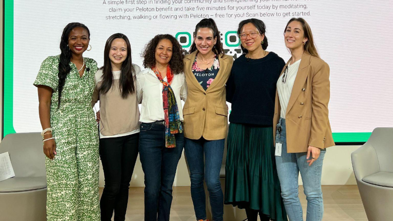 six people standing on a stage
