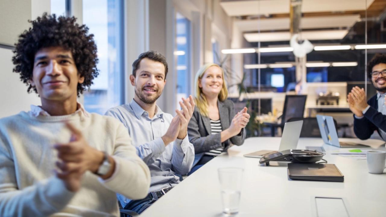 people clapping at a meeting