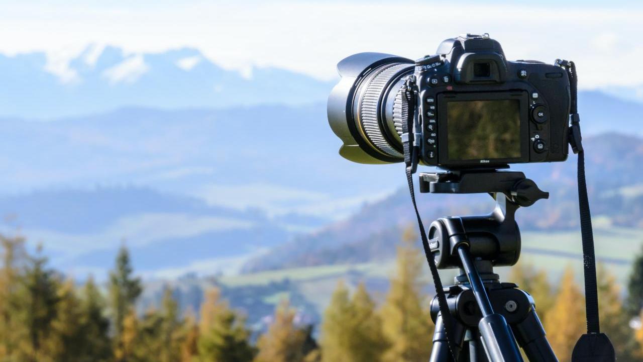 Camera on a tripod looking out over a mountain landscape