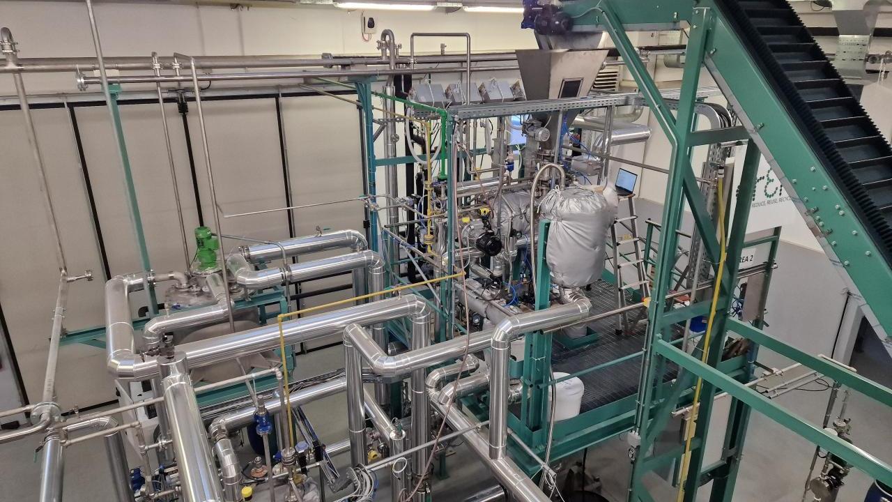 A large machine with many pipes in a large open room.