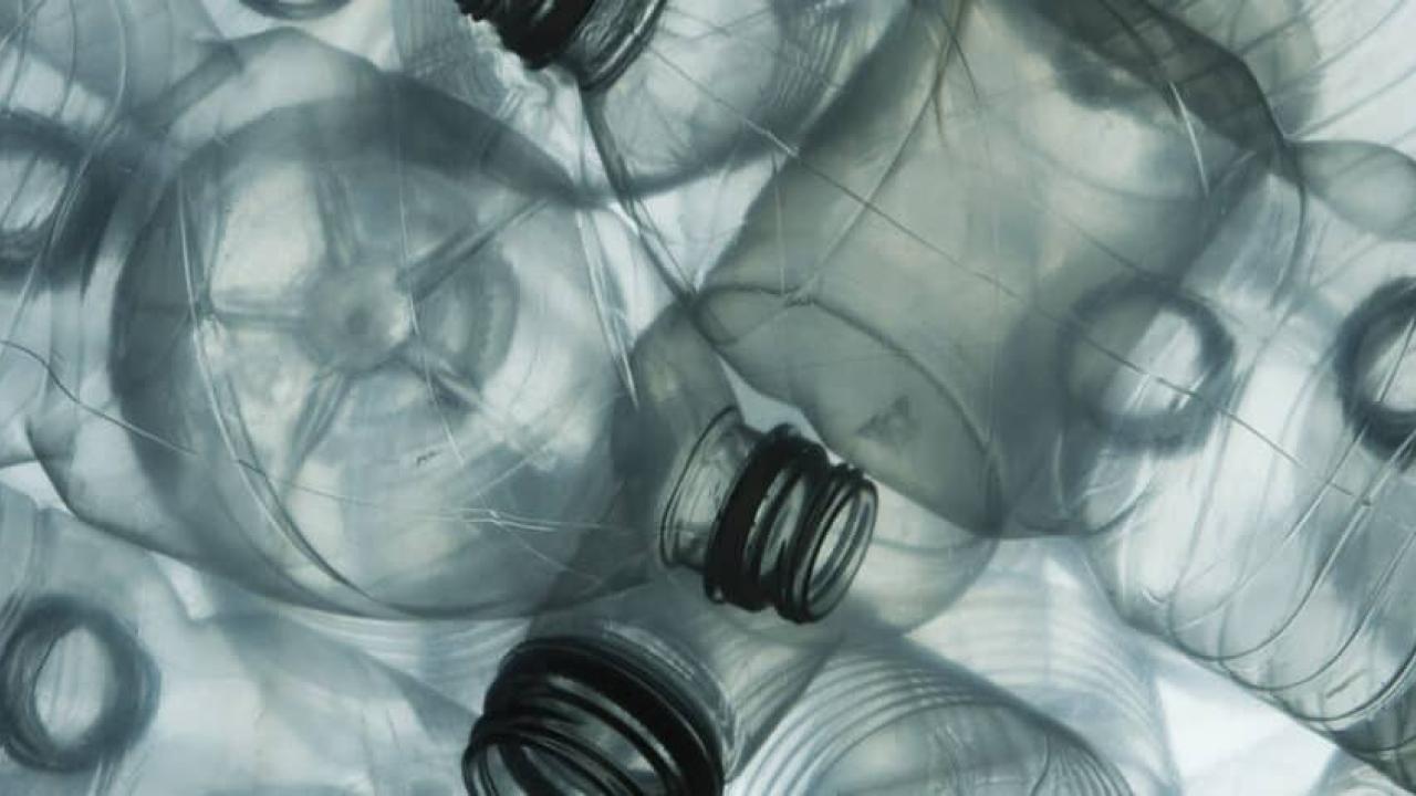 close up to a pile of clear plastic bottles.