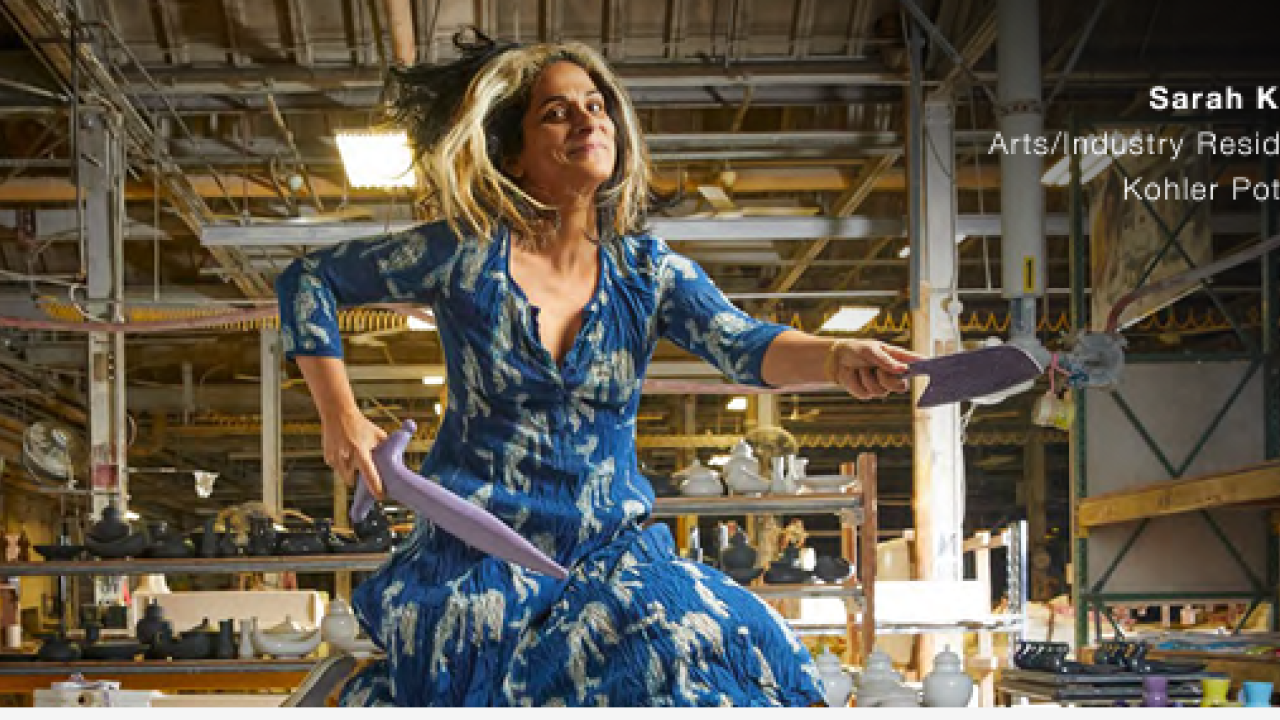 Sarah Kahn jumping in the air with ceramic knives.