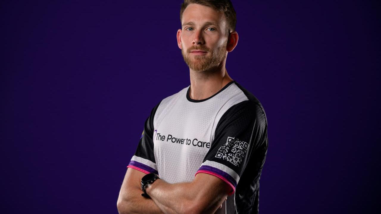Thomas Green in a running jersey. "The Power to Care" on the front.