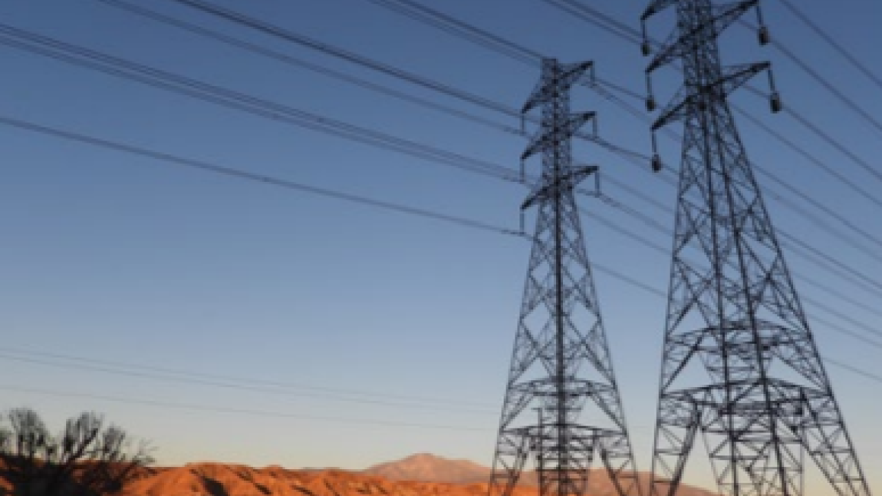 two electricity towers in a desert landscape