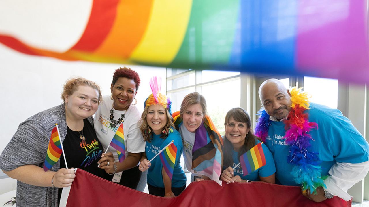 DeAnna Lowe, Cicely Hart, Kristie McKillip, Susan Wilde, Julie Orben and Harley McCorkle with pride flags