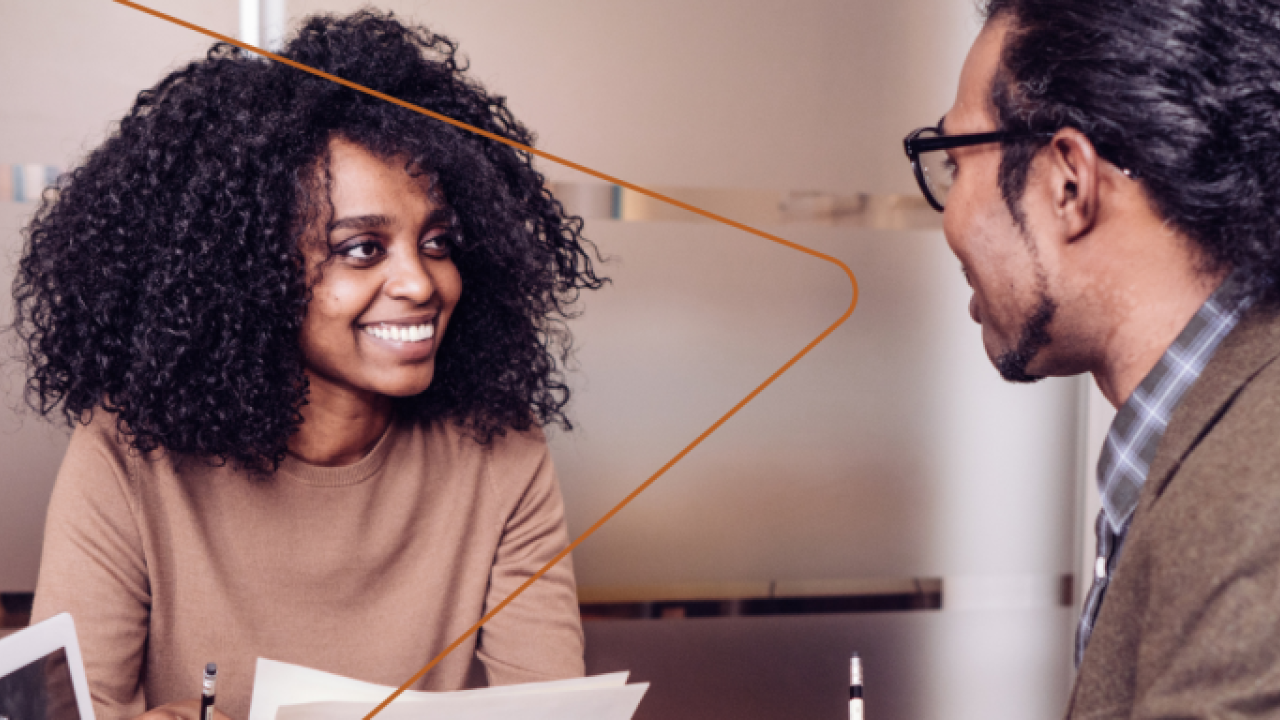 two people talking in an office space