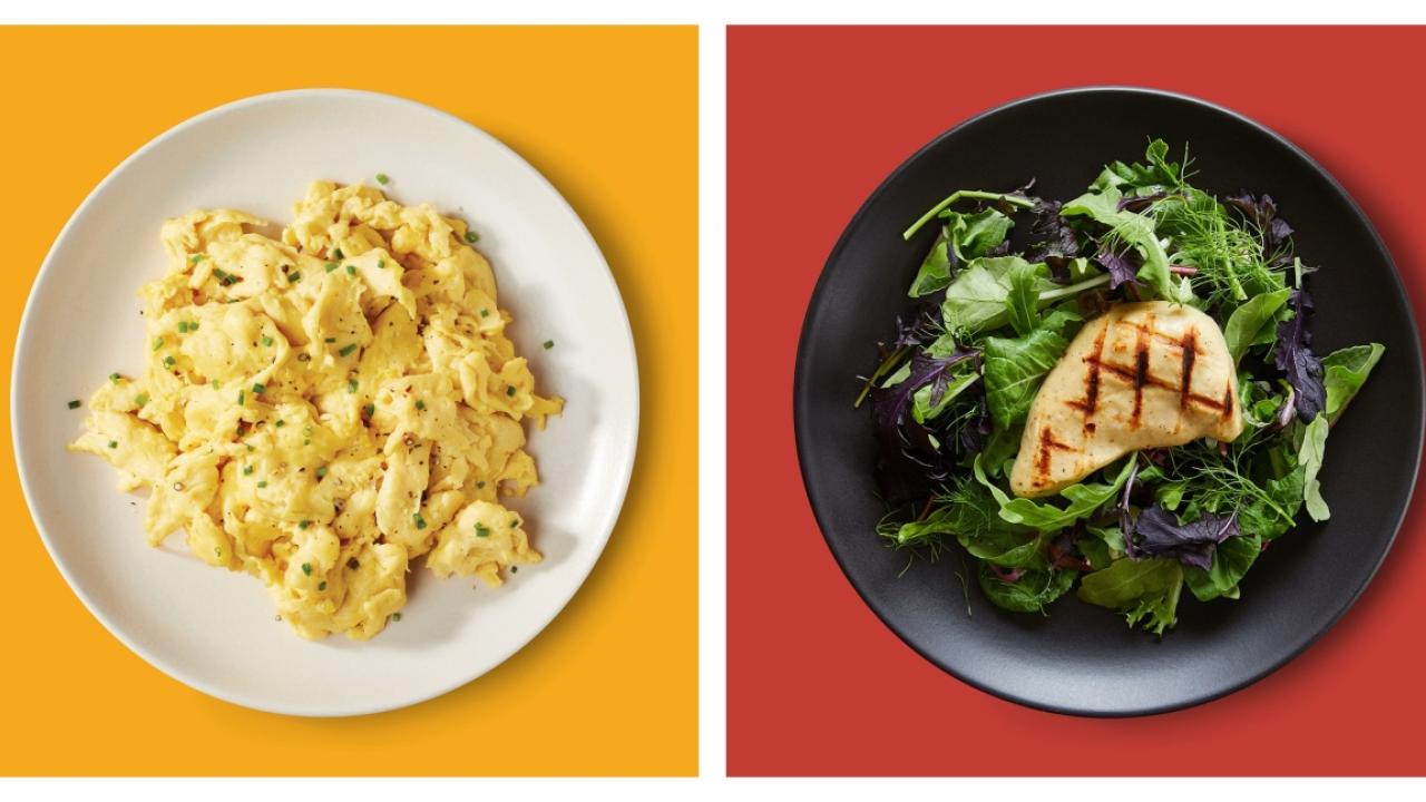 side by side plates of alternative proteins, one of 'scrambled eggs' and on of a 'chicken breast' on salad greens