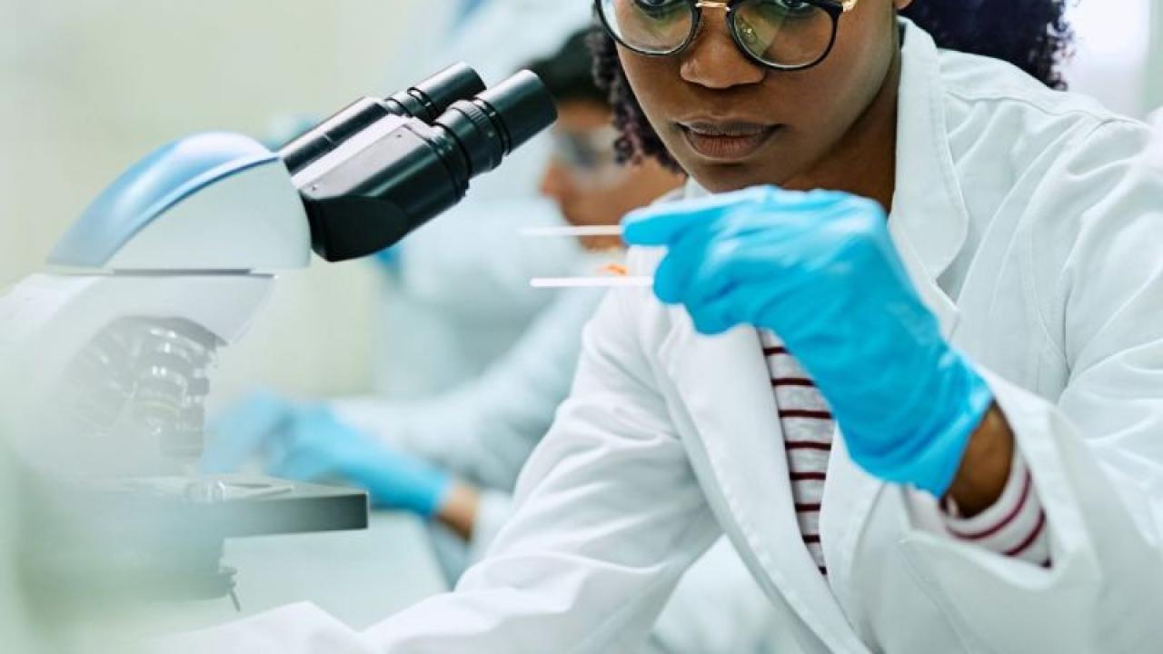 A scientist examining a slide