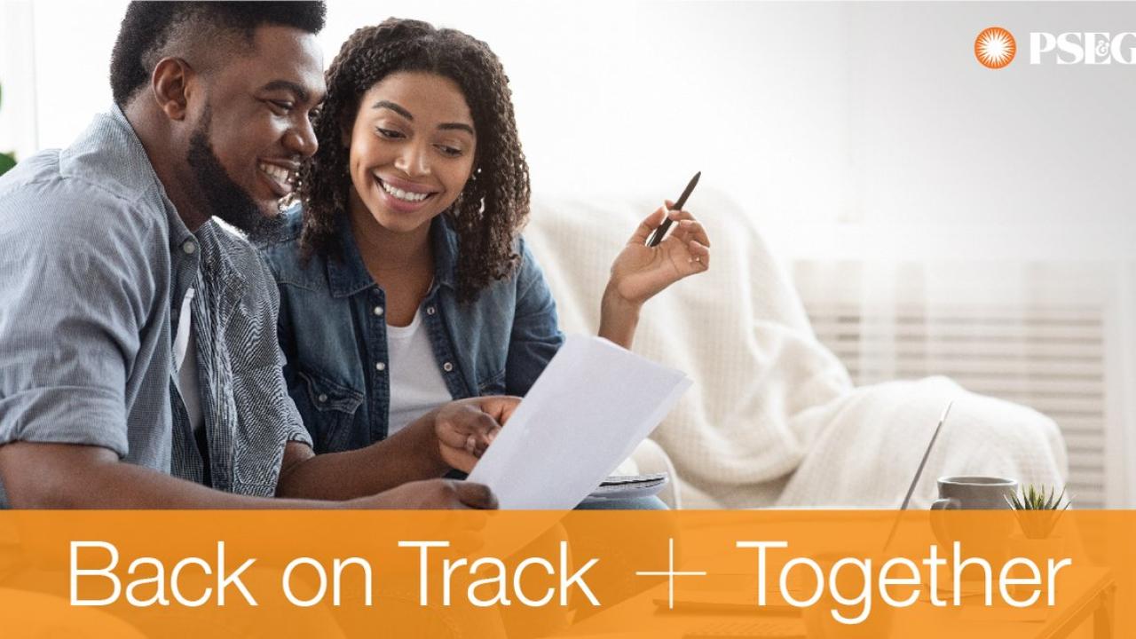 Back on Track Together. Man and woman are looking at a bill together.