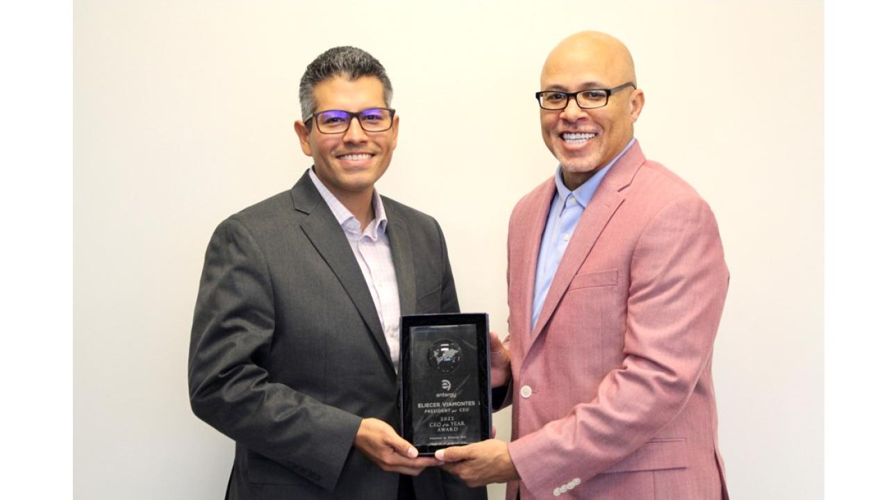 Eliecer “Eli” Viamontes receiving award from another person