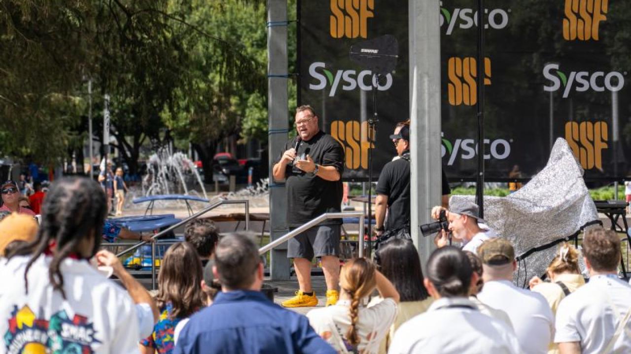 person speaking at outdoor event