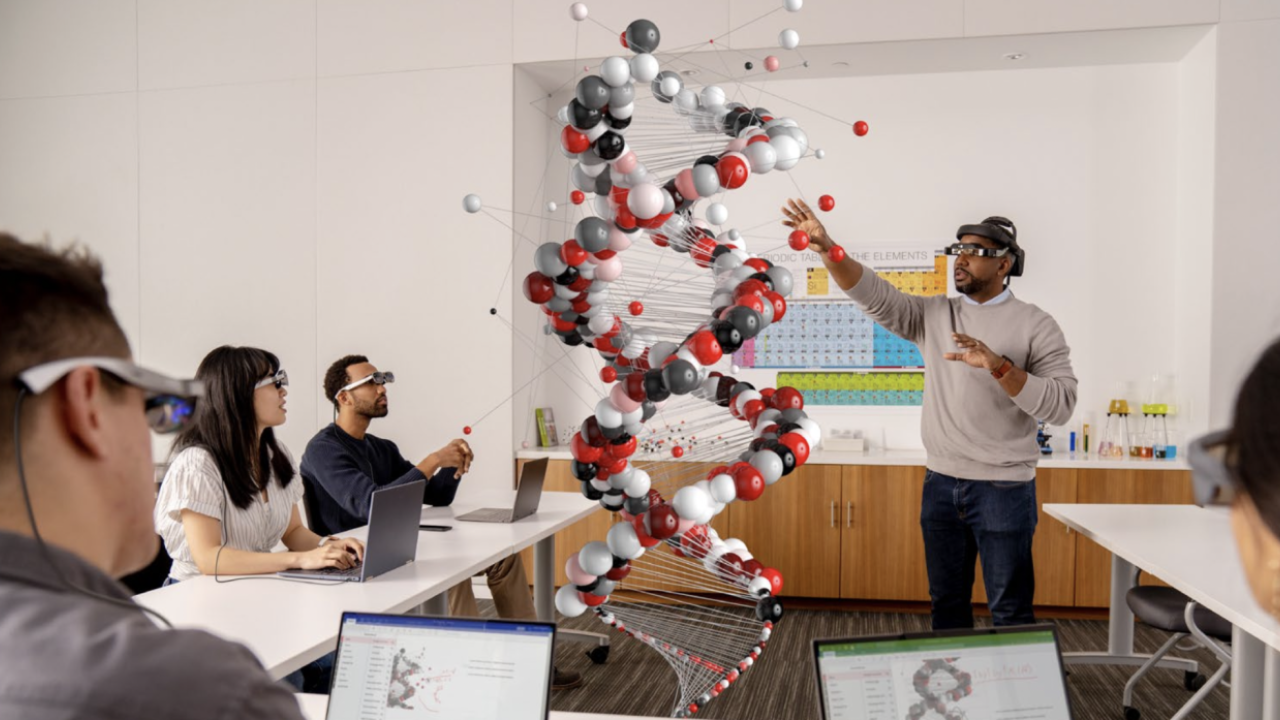 people wearing VR headsets looking at a representation of a DNA strand