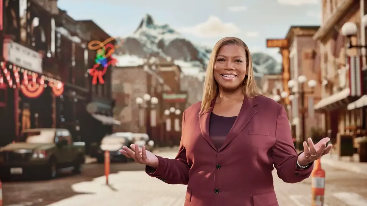 Queen Latifa on a small town main-street. Mountains in the distance