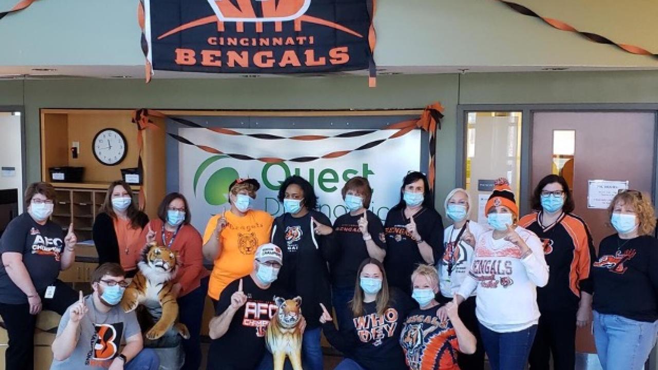 group photo with Bengals flag in background