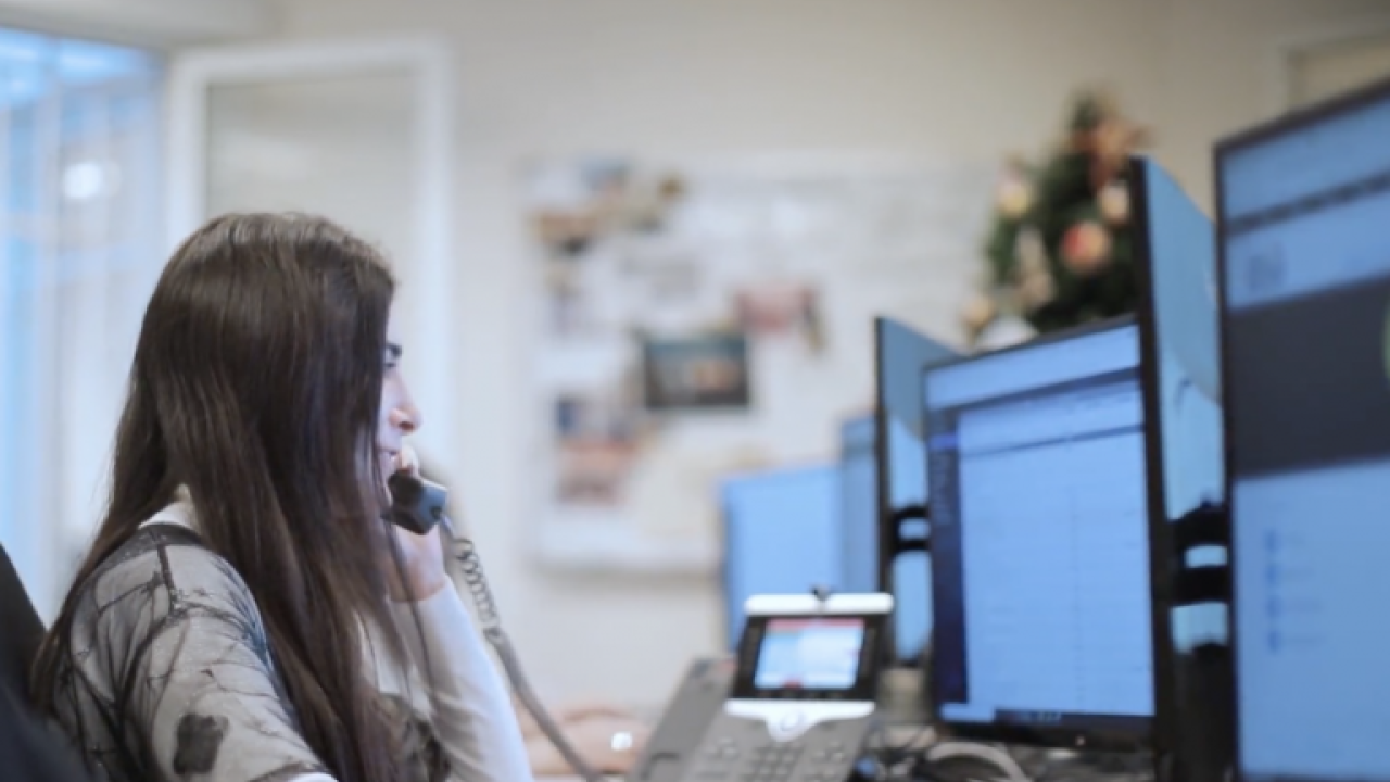Woman on the phone at the computer