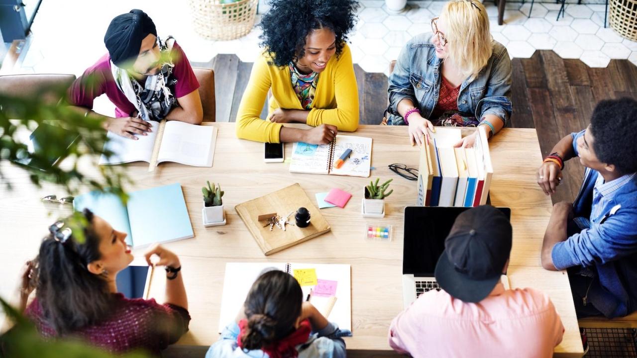 7 people working around a table