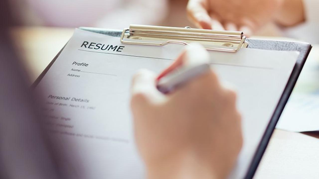 person with a clipboard with a resume