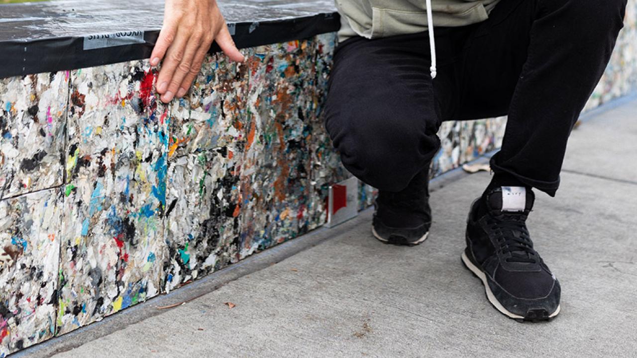 hand on recycled building material